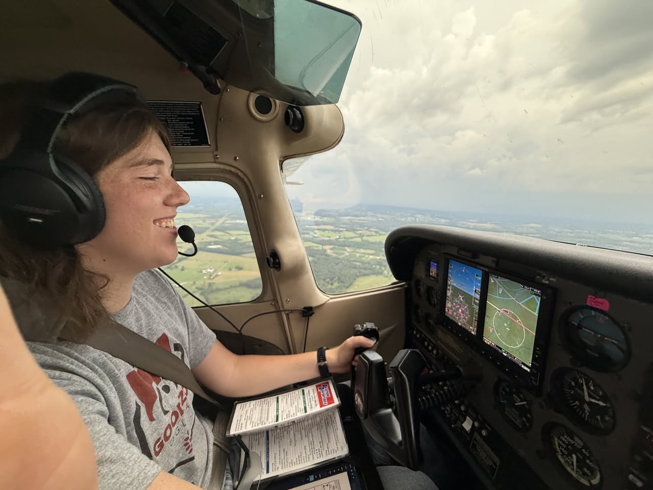 A smiling flight student racing ahead of the stormfront.