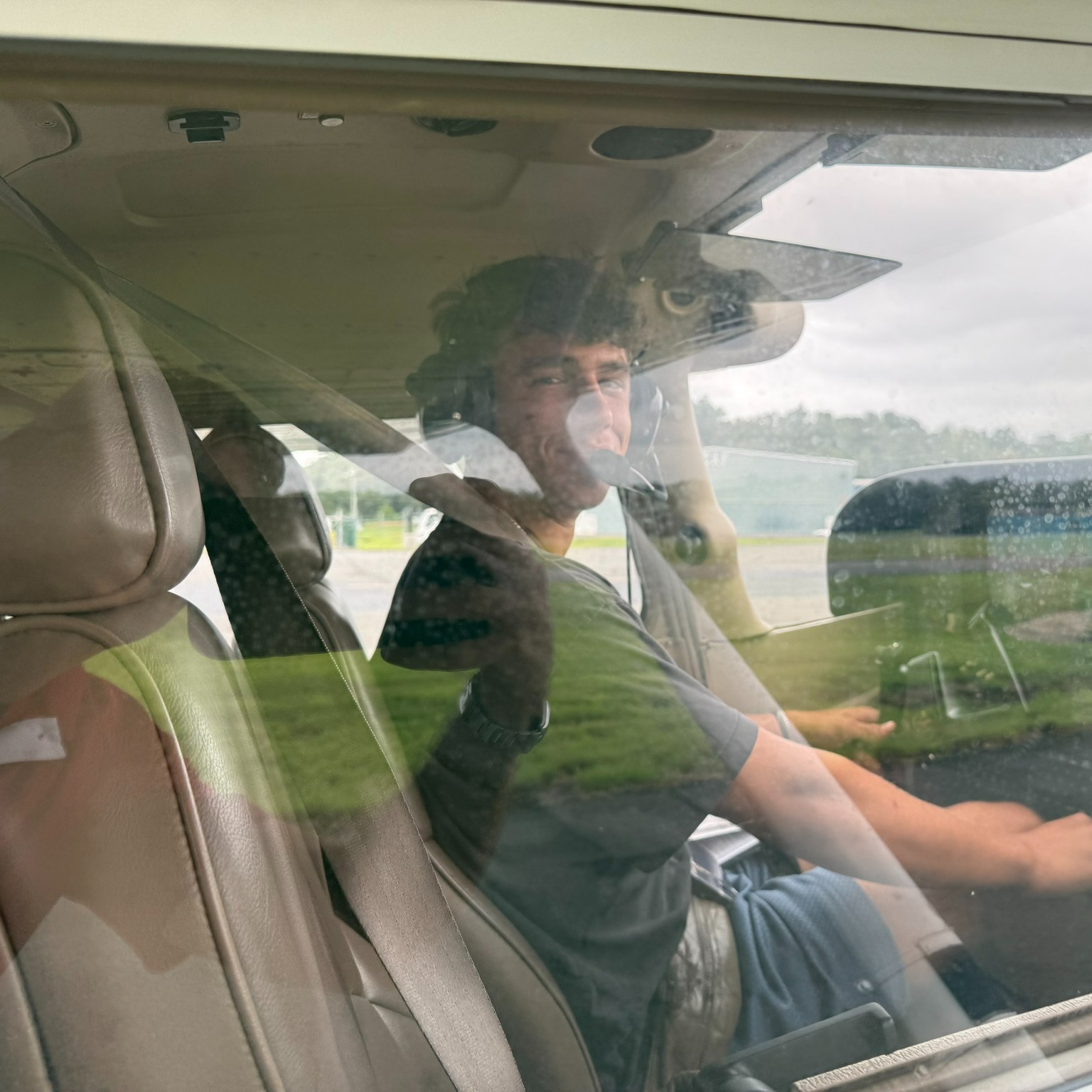 A young student in the cockpit about to solo for the first time.