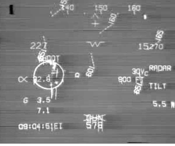 A grainy HUD/FLIR recording still with targeting symbology and a timestamp.